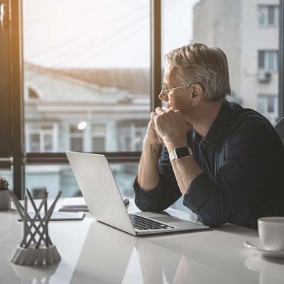 Investor gazing out of a window